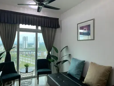 a living room with a couch and a large window at The Rain Homestay Meru Raya in Ipoh