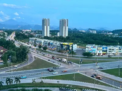a highway in a city with traffic and buildings at The Rain Homestay Meru Raya in Ipoh