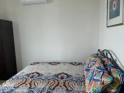a bed with a blanket on it in a bedroom at The Rain Homestay Meru Raya in Ipoh