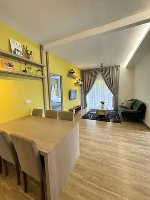 a living room with a dining table and a couch at Eisya Homestay Emerald Avenue Brinchang in Brinchang