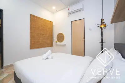 a bedroom with a white bed and a window at Ipoh Hillview Boutique Guesthouse by Verve 10 pax in Ipoh