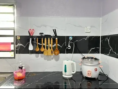 a kitchen counter with a toaster and utensils at Ammaiti Homestay Kulim in Kulim