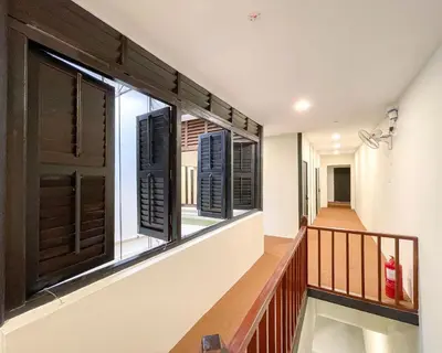 a hallway with windows in a house at INN Lebuh Melayu in George Town