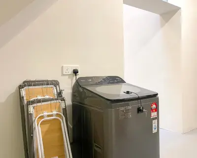 a room with a trash can next to a wall at INN Lebuh Melayu in George Town