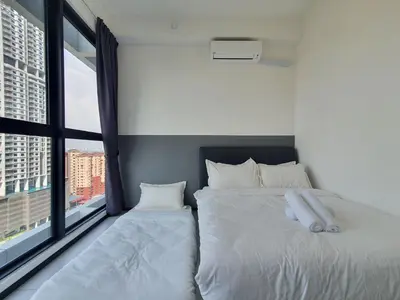 a bedroom with two beds and a large window at Urban Suites Penang P2 LDL WL in Jelutong