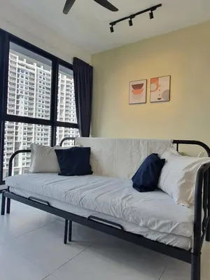 a white couch with blue pillows in a room at Urban Suites Penang P2 LDL WL in Jelutong