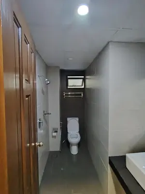 a small bathroom with a toilet and a sink at Highland Hideaway 1 Bedroom Apartment at Equatorial Hill Resort in Brinchang