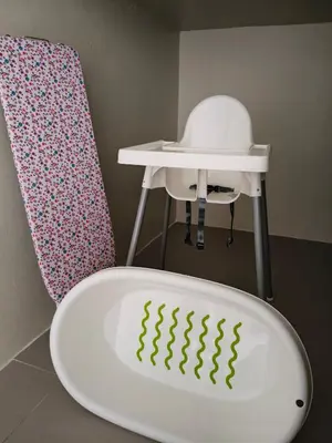 a white bath tub next to a chair and a table at Penthouse with 3 bedrooms, Golden Hills Night Market in Brinchang
