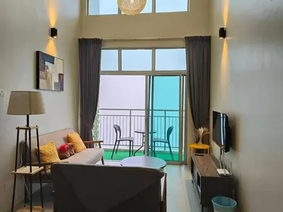 a living room with a couch and a large window at Penthouse with 3 bedrooms, Golden Hills Night Market in Brinchang
