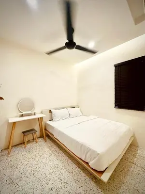 a white bedroom with a bed and a ceiling fan at New Grand Muji Style Villa at Central Penang 16pax in Bukit Lada