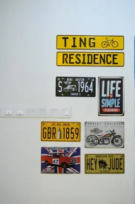 a bunch of signs hanging on a wall at Ting Residence in Sitiawan