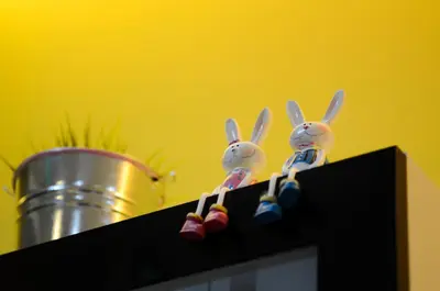 two toy rabbits sitting on top of a black shelf at Ting Residence in Sitiawan