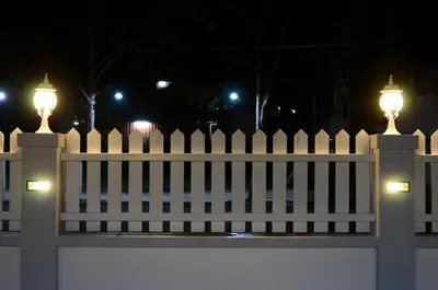 a white fence with two lights on top of it at Ting Residence in Sitiawan