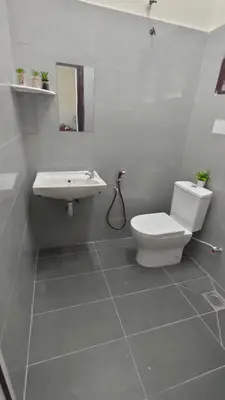 a bathroom with a toilet and a sink at 77 homestay 5Min to Leaning Tower in Teluk Intan