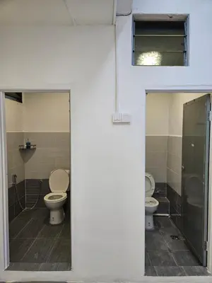a bathroom with two toilets in a room at SS TWO Hostel Penang in George Town
