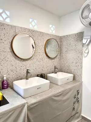 a bathroom with two sinks and two mirrors at Stay Meow Meow Mount Erskine Near Gurney Plaza, Adventist in George Town