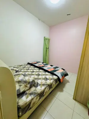 a bedroom with a bed in a room at AYAAN DELUXE HOMESTAY FREE WiFi in Cameron Highlands
