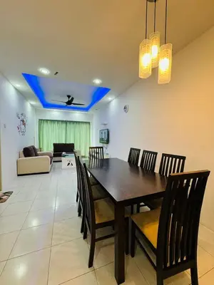 a dining room table and chairs in a living room at AYAAN DELUXE HOMESTAY FREE WiFi in Cameron Highlands