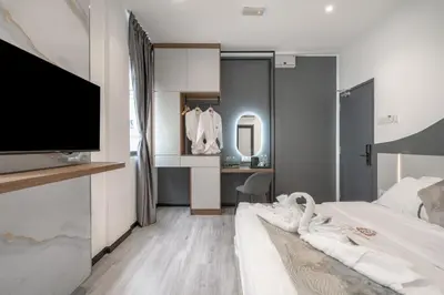 a bedroom with a bed with a flat screen tv at Saturn Hotel in George Town