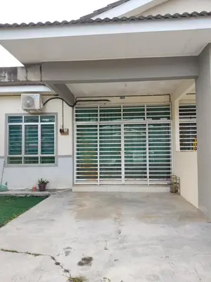 a garage with closed blinds on a house at Homestay NAQ D' Kuala Kangsar in Kuala Kangsar