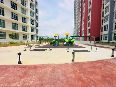a playground with slides and play equipment in front of buildings at The Anderson Haven Family Suites - Ipoh 2-bedroom Apartment in Ipoh
