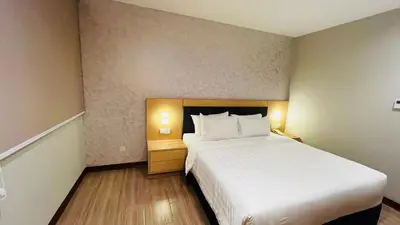 a bedroom with a large white bed in a room at Forum Hotel Penang in George Town
