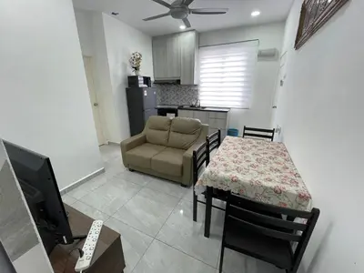 a living room with a table and a couch at Penang Studio Homestay at Kelawai Rd, Georgetown by SK Vacation Homes in George Town