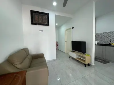 a living room with a couch and a flat screen tv at Penang Studio Homestay at Kelawai Rd, Georgetown by SK Vacation Homes in George Town