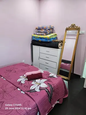 a bedroom with a bed with a dresser and a mirror at 3BR Condo at Gelugor by Hana Suite in Jelutong