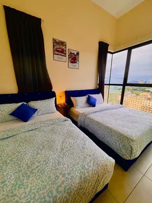 two beds in a room with a window at Large Familystay 3BR Stunning Sea & City-view, Georgetown in Jelutong