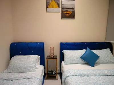 two beds sitting next to each other in a room at Premium Familystay Urban Suites-3BR 14 pax in Jelutong