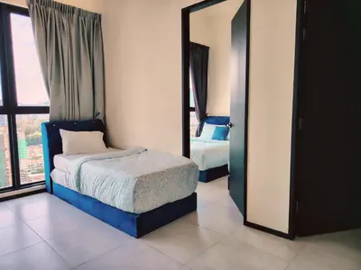 a bedroom with two beds and a mirror at Premium world-class House-Sea & City View Netflix in Jelutong
