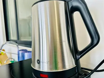 a stainless steel kettle sitting on top of a stove at Premium world-class House-Sea & City View Netflix in Jelutong