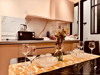 a kitchen with wine glasses on a counter at Premium world-class House-Sea & City View Netflix in Jelutong