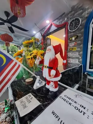 a santa claus figurine on a counter in a restaurant at SunStar Hotel in Kampong Batu Maung