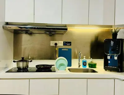 a kitchen counter with a sink and a stove at Georgetown Seaview 5 Min To Gurney N Straits Quay Washing Machine N Dryer in Tanjong Tokong