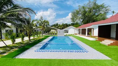 a swimming pool in the yard of a house at Farmstay Laman Zulfaqar in Lahat