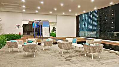 a lobby with chairs and a table and a building at The Best Luxury suites Asia Spacious 3BR Sea View in Jelutong