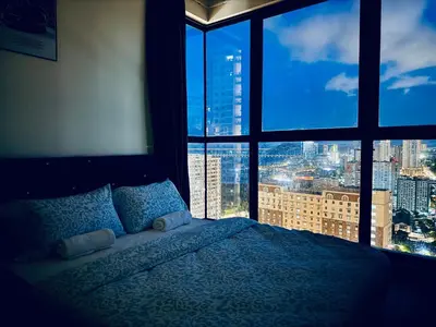 a bedroom with a bed and a large window at The Best Luxury suites Asia Spacious 3BR Sea View in Jelutong