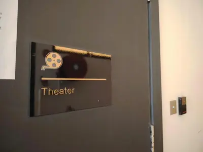 a door with a sign that says theater on it at Big Family stay urban Large Pool & Sea view Netfix in Jelutong