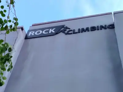a rock climbing sign on the side of a building at Big Family stay urban Large Pool & Sea view Netfix in Jelutong
