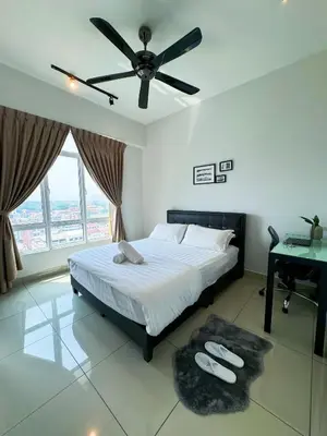 a bedroom with a bed with a ceiling fan and a desk at Ipoh The Majestic Imperial Tower Ipoh Town Centre, 3BR Fully Air Con Homestay in Ipoh