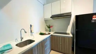 a kitchen with a sink and a black refrigerator at Ipoh The Majestic Imperial Tower Ipoh Town Centre, 3BR Fully Air Con Homestay in Ipoh