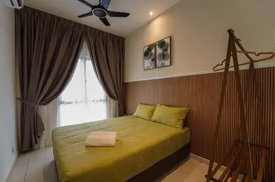 a bedroom with a yellow bed with a ceiling fan at Horizon Ipoh 8Pax 3R2B - Tropical Bali Retreat in Ipoh