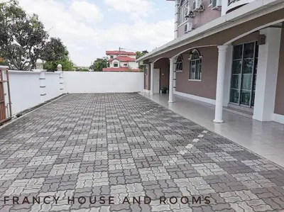 a driveway of a house with a white fence at Castle Bungalow In Bercham Ipoh in Kampong Tasek