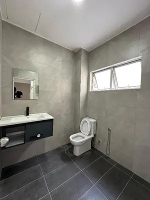 a bathroom with a toilet and a sink and a mirror at 3Story Family Suites 7pax Ikea Batu Kawan 5min in Batu Kawan