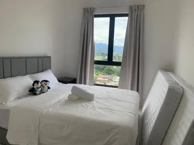 two stuffed animals sitting on a bed with a window at Veneto Ipoh homestay 3BR with infinity pool in Ipoh