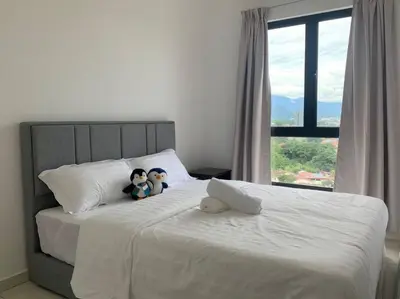 two stuffed animals sitting on a bed with a window at Veneto Ipoh homestay 3BR with infinity pool in Ipoh