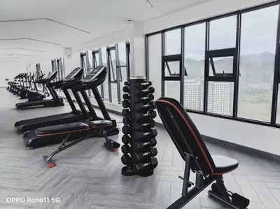 a row of chairs in a gym with windows at Veneto Ipoh homestay 3BR with infinity pool in Ipoh
