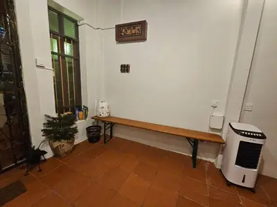 a room with a wooden bench and a window at HOME Penang in George Town